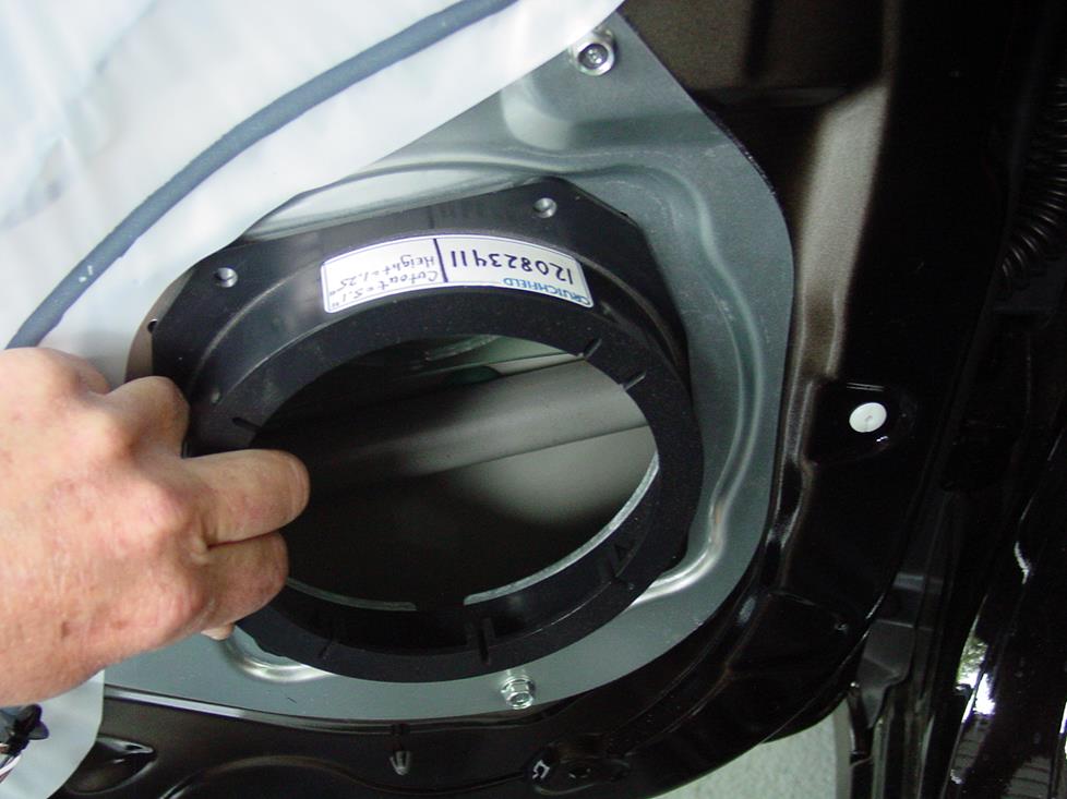 Mounting the adapter bracket in the Soul's front door (Crutchfield Research Photo)