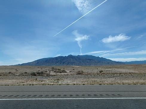 Jet contrail over a mountain in New Mexico