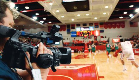 Canon professional camcorder in use at a sporting event.