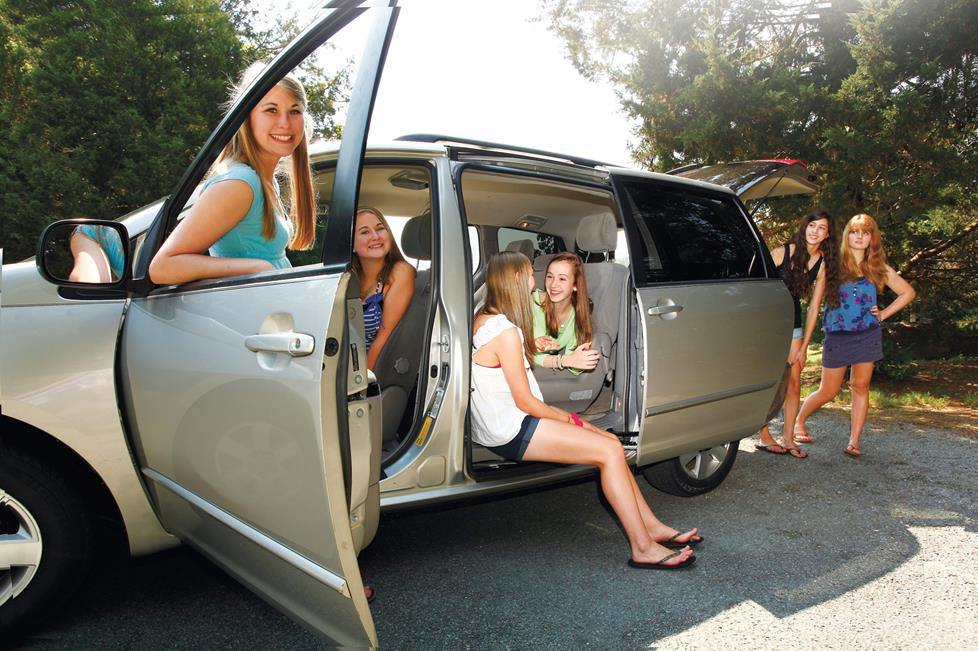 Teenagers enjoying the minivan's new stereo