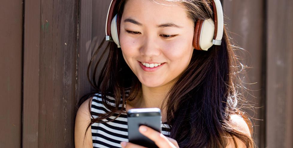 Woman listening to music on her iPhone.