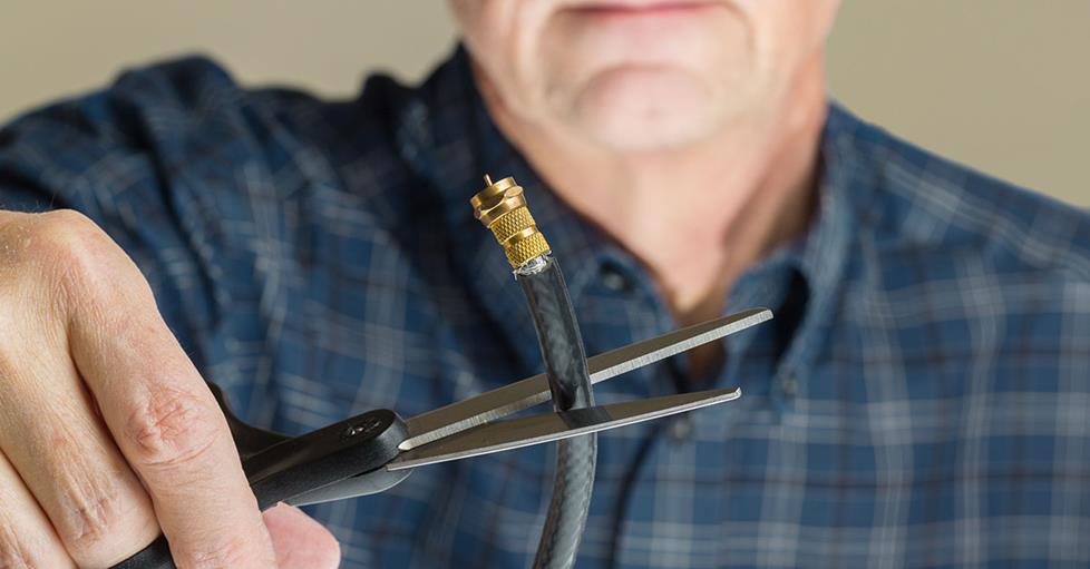 Man cutting coaxial cable