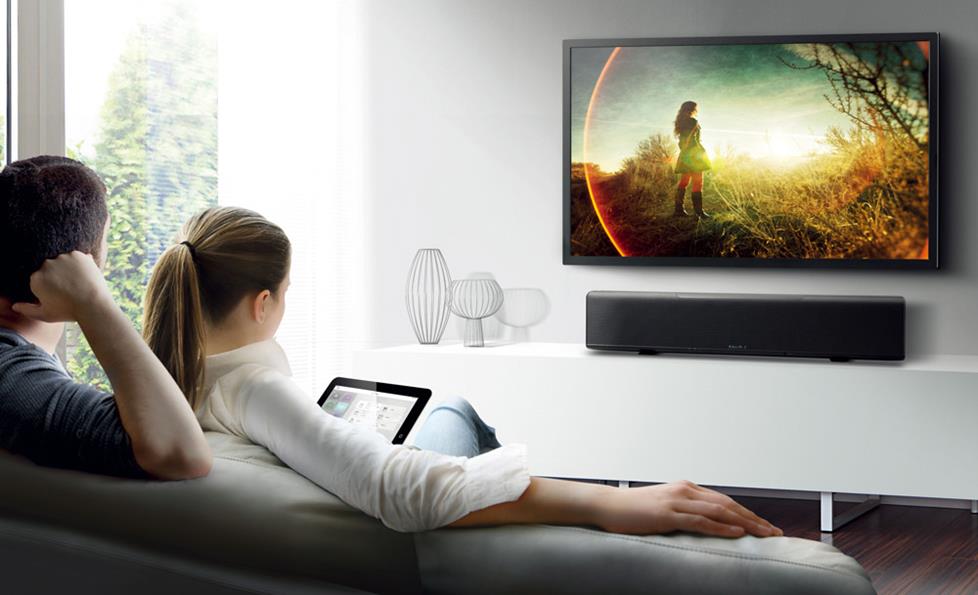Place a sound bar on a stand below a wall-mounted TV