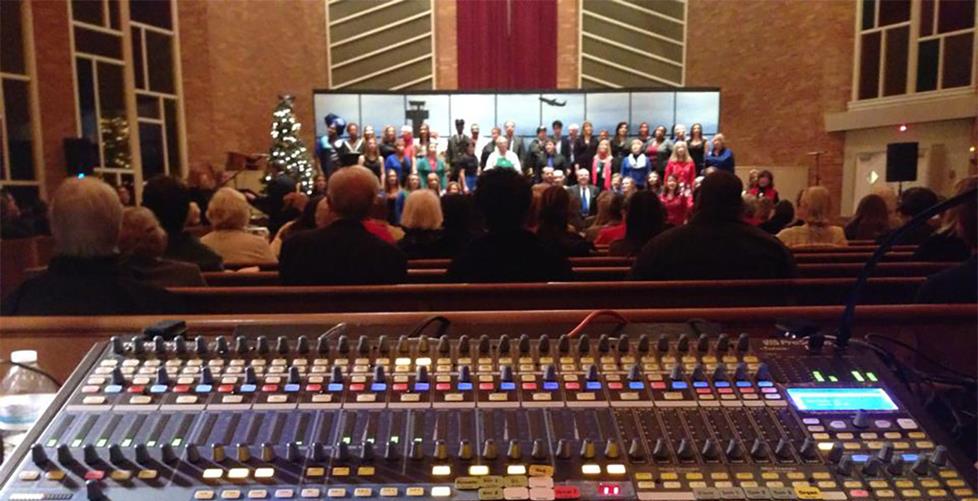 mixing board in a church with choir singing