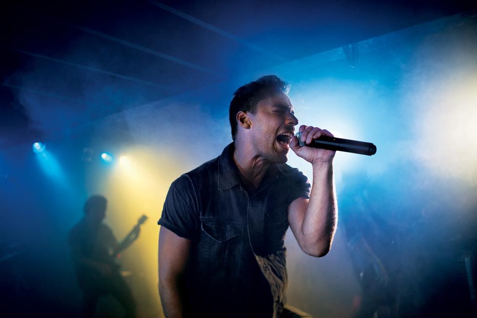 Singer on stage with wireless handheld microphone
