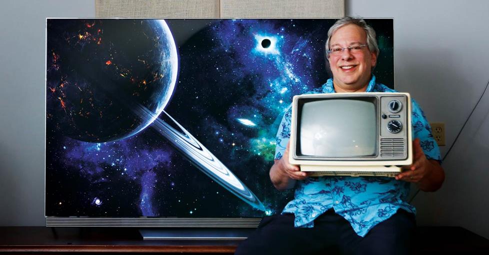 our sales advisor, Marshall, with a new 4K HDR TV, and a small "portable" tube TV