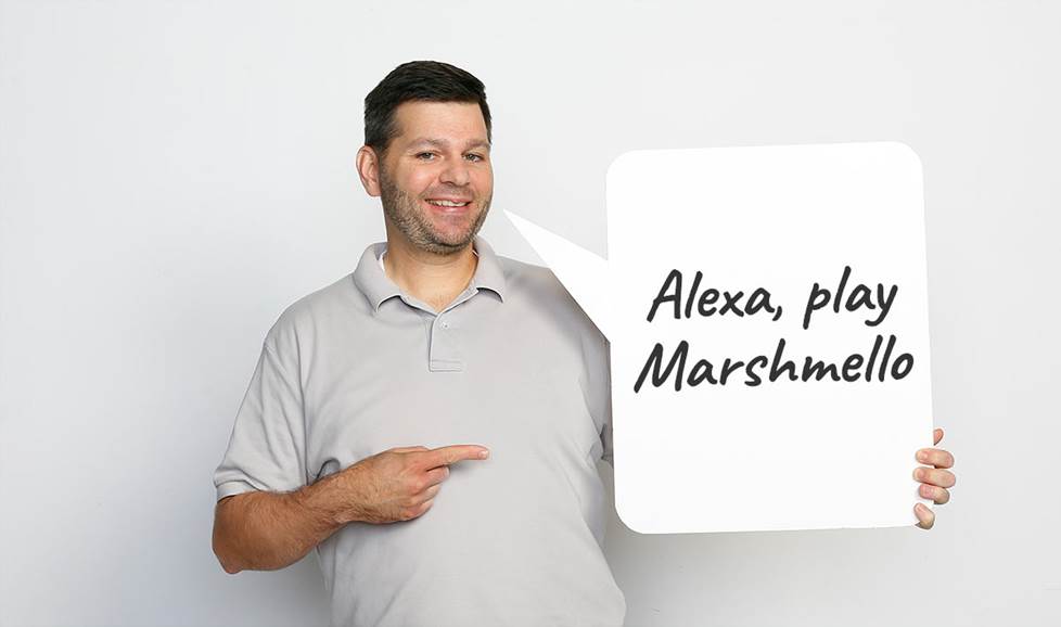 Man holding speech bubble saying "Alexa, play Marshmello"