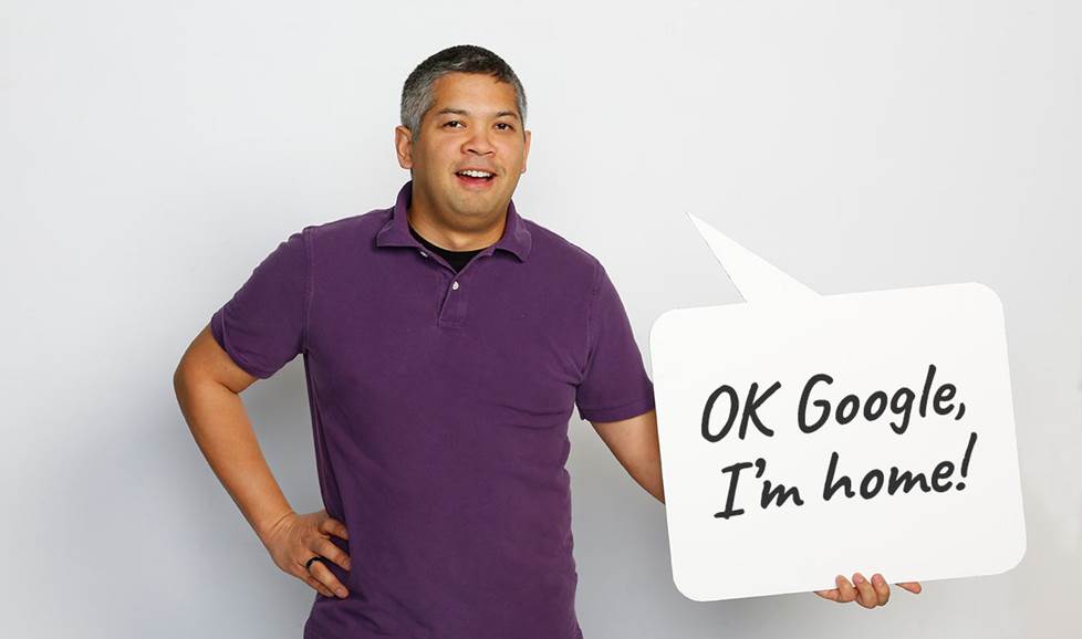 Man holding speech bubble that says "OK Google, I'm home"