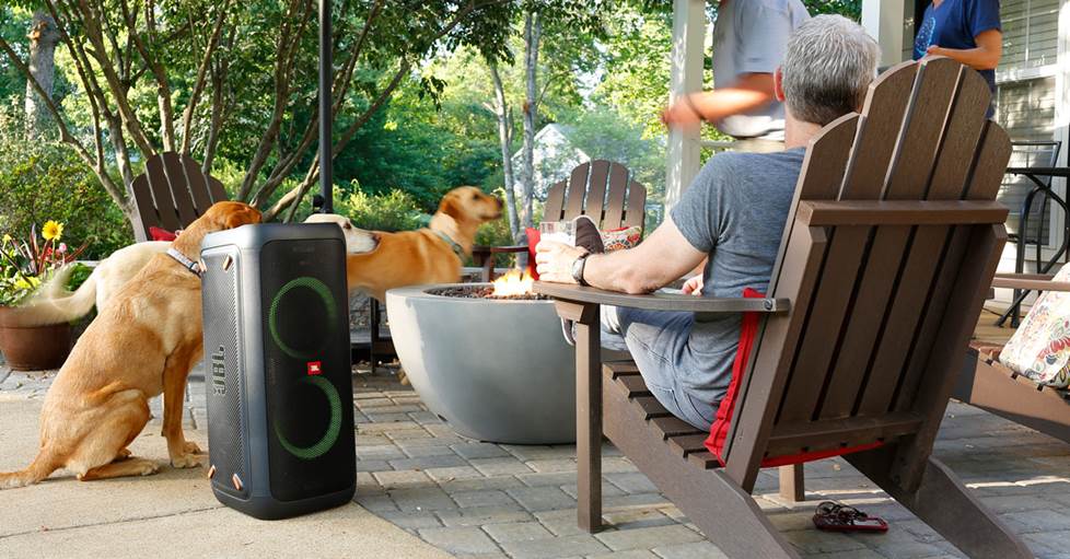 JBL PartyBox 300 Portable Bluetooth® speaker with light display in use near a fire pit.