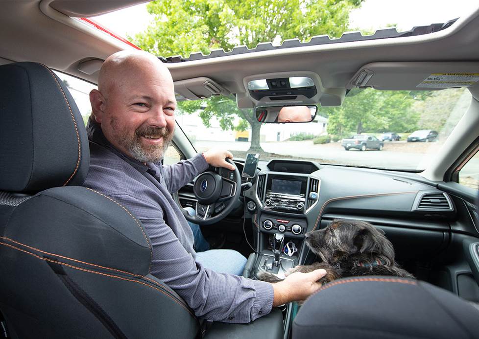 JR behind the wheel, with his dog riding shotgun