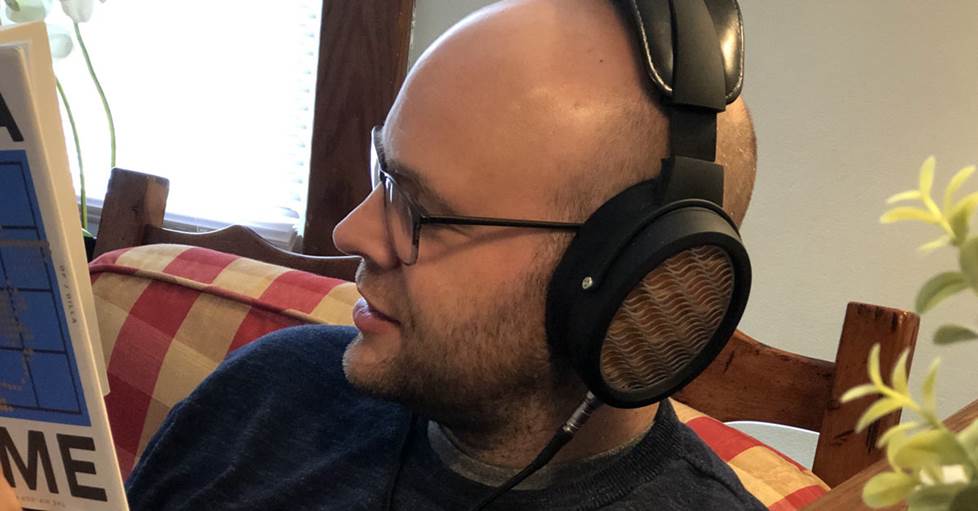 photo of Jeff listening to the headphones while reading a book
