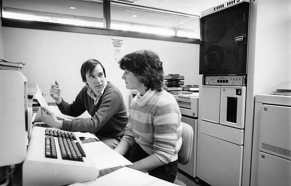 vintage black and white photo of employees using very large IBM computer