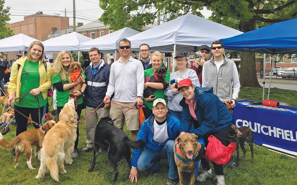 Crutchfield employees and SPCA employees gather for a photo at a volunteer event.