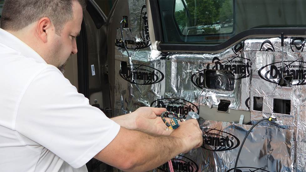 Man installing Dynamat on a car door