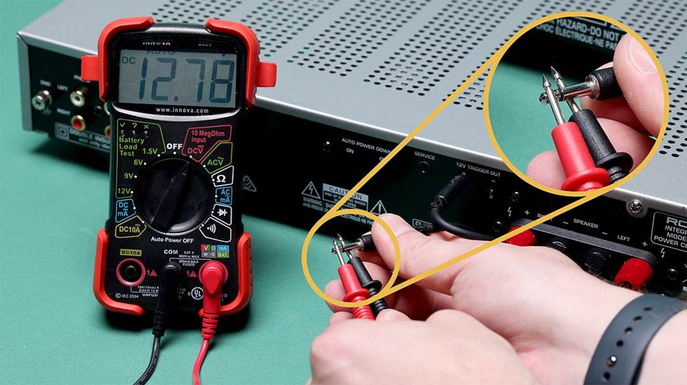 Multimeter with probes connected to minijack cable