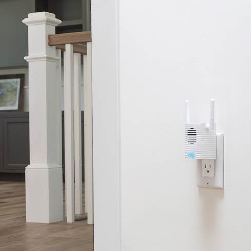 Ring Chime Pro Wi-Fi extender plugged in near staircase.