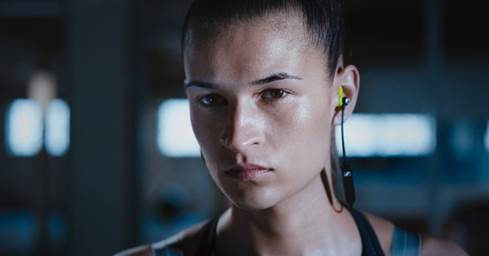 Woman wearing Sennheiser CX SPORT earbuds