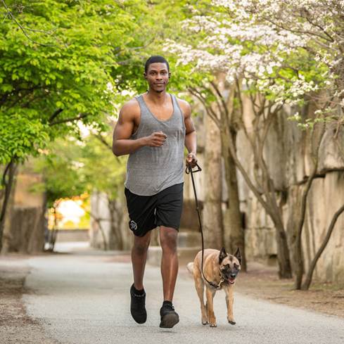Man running and wearing Klipsch T5 Sports headphones