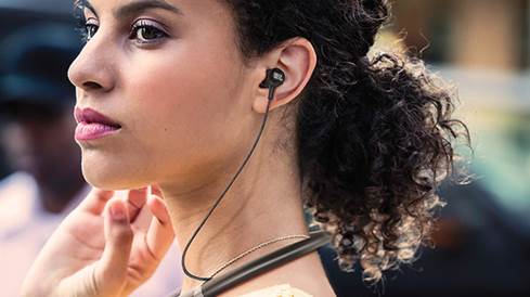 Woman wearing JBL Live 200BT wireless neckband headphones