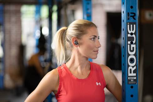 Woman working out wearing Cleer Ally earbuds