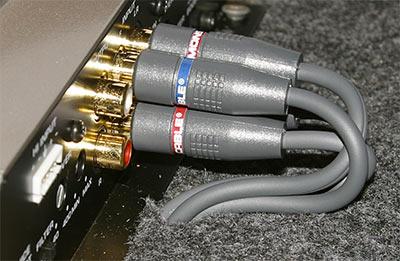 RCA cables routed through slits in the vehicle's carpet