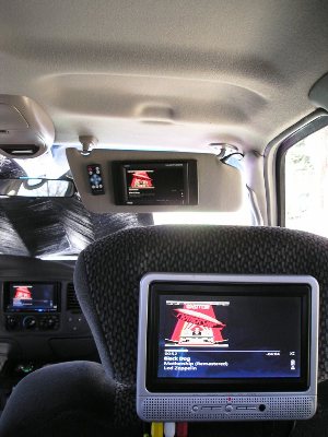 1 of two Insignia LCD Screens on headrest with a Pyle 7-inch video screen mounted to sunvisor for front passenger
