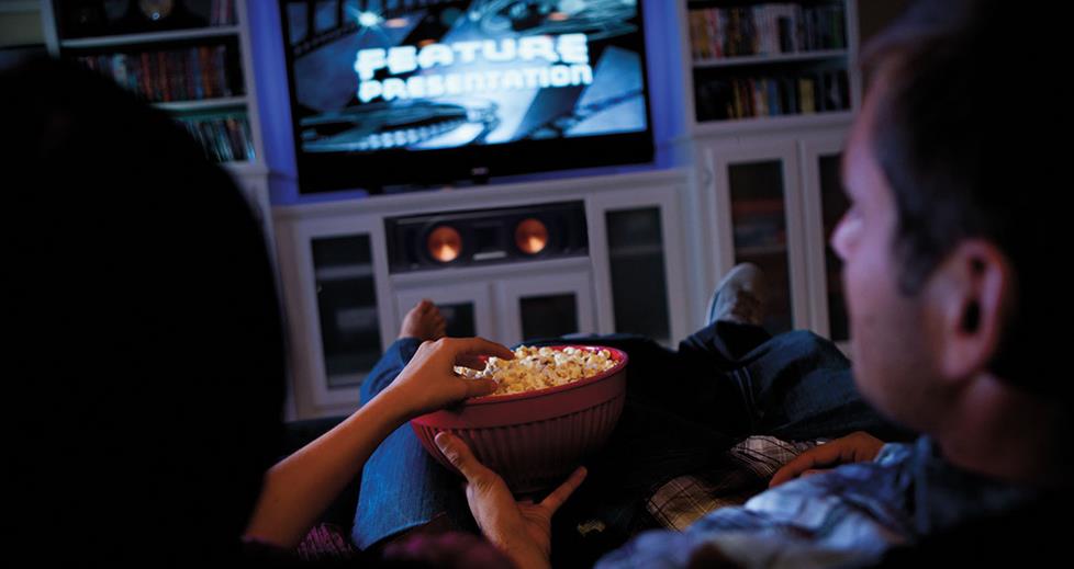 Couple enjoying their home theater.