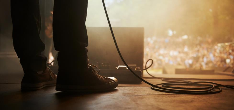 Musician on stage with cables