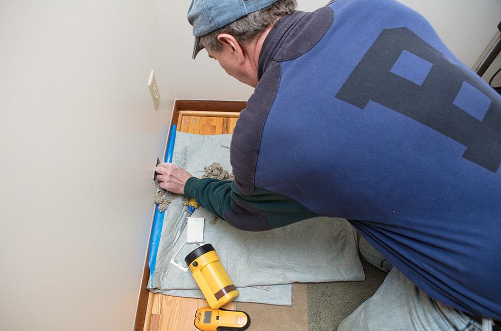 Installer placing drop cloth on the floor