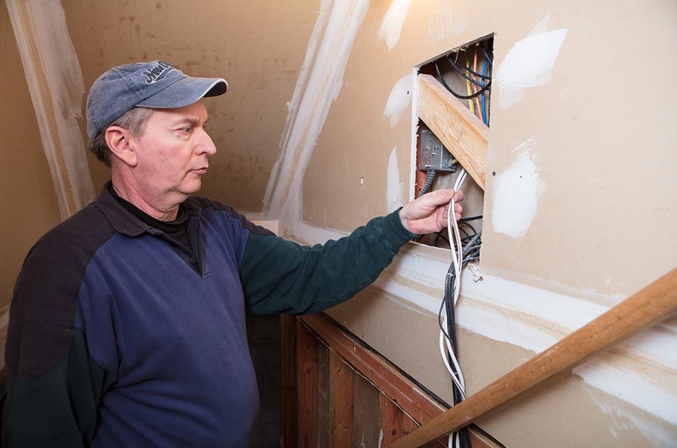 Installer working inside wall opening