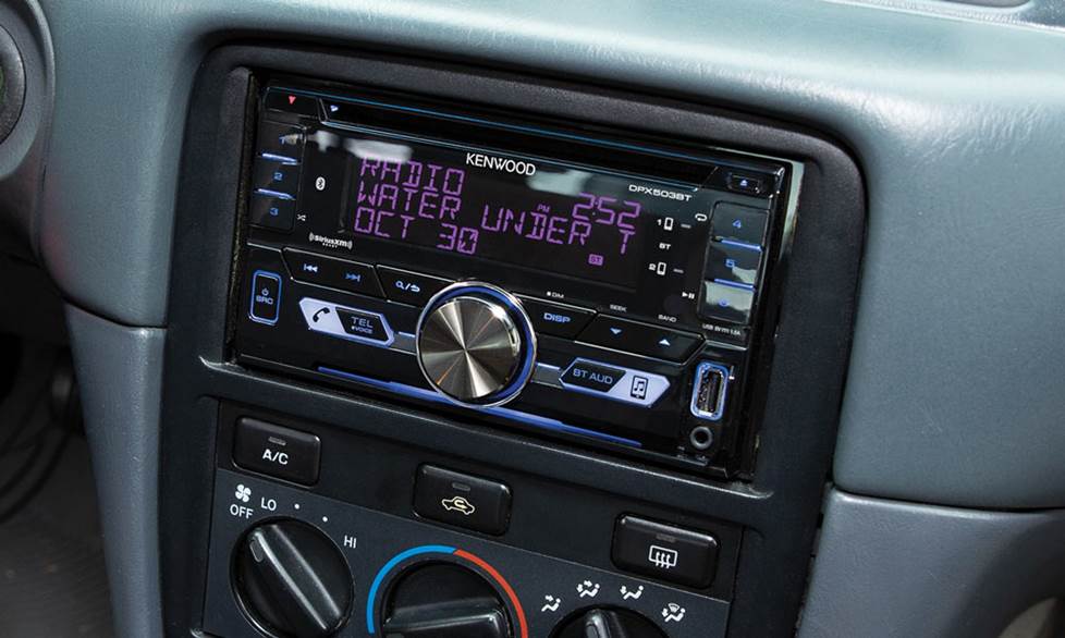 The Kenwood DPX503BT receiver mounted in the dash