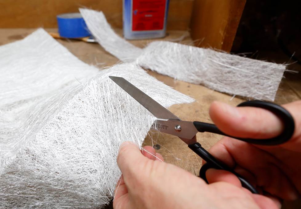 cutting fiberglass mat with scissors