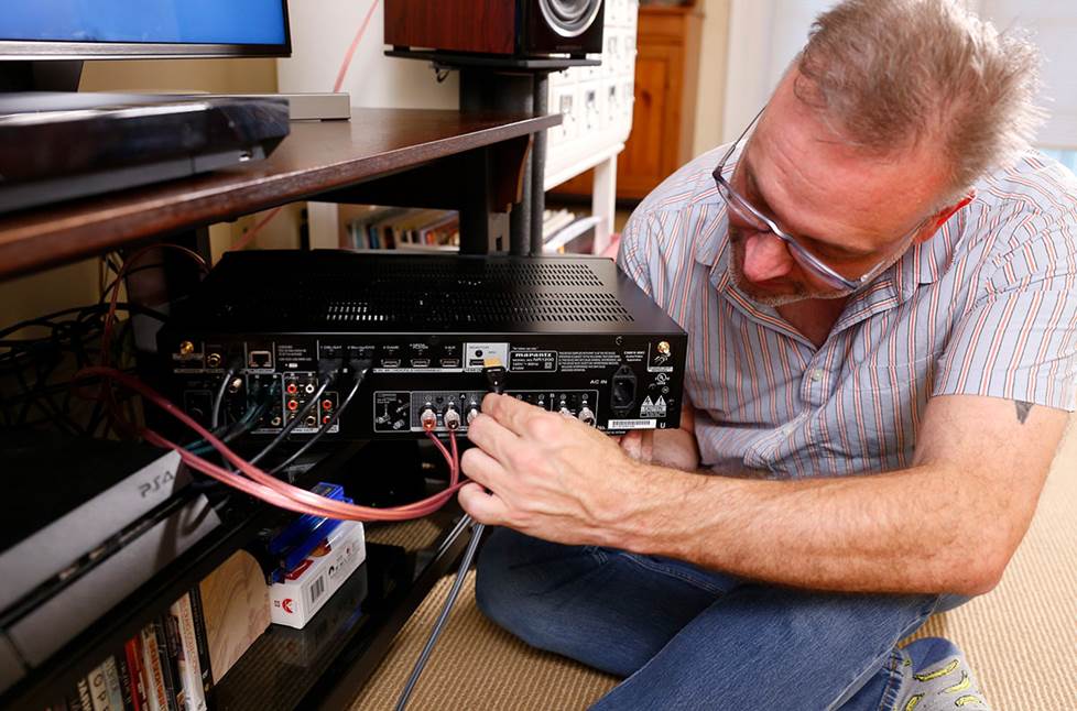 The author hooking up cables to a receiver