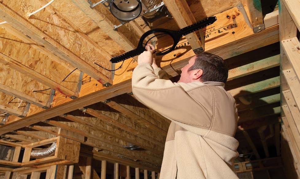 Mark installing a ceiling bracket.