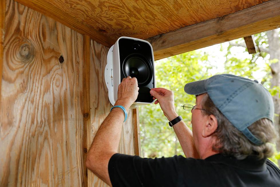 Norm installing Tara's treehouse Sonos system