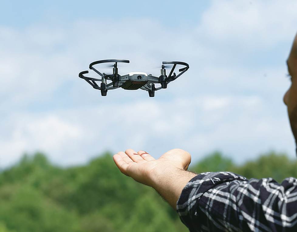 Drone hovering over a man's hand