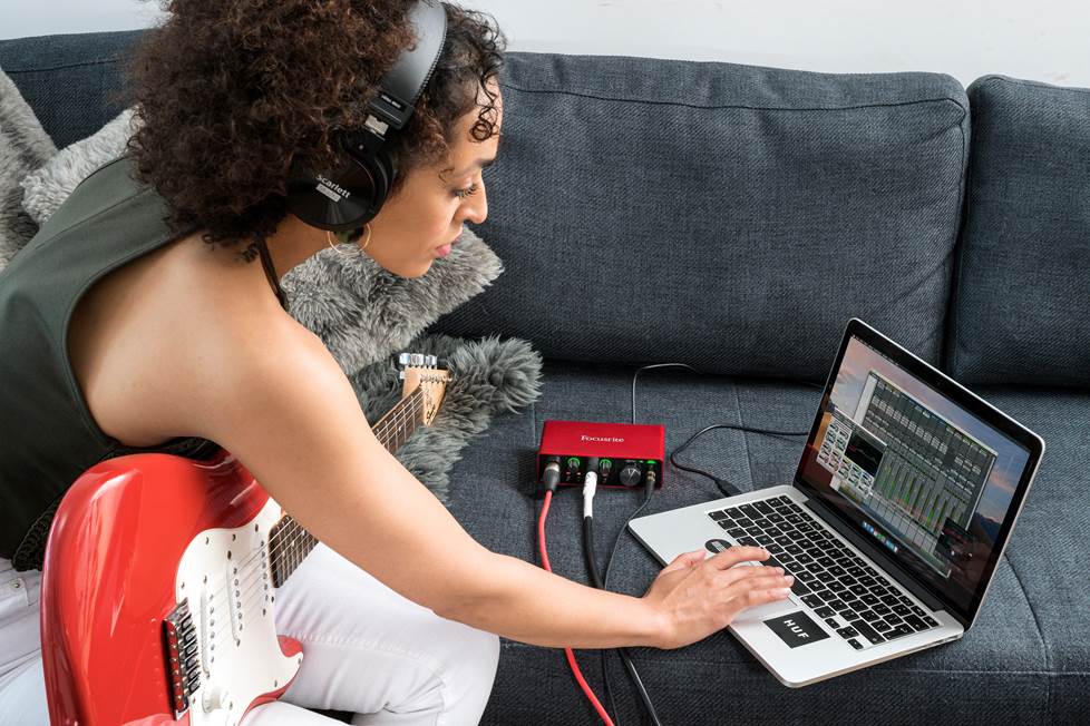woman using usb interface to record guitar