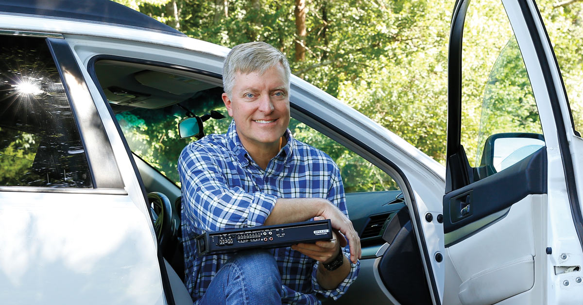 Woman Turning Up The Volume On The Car Radio Stock Photo