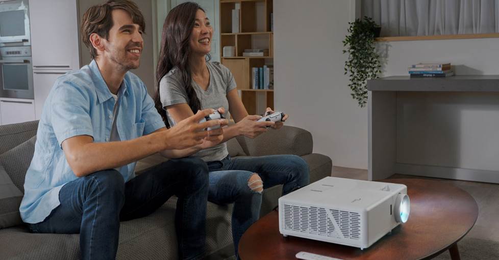 A couple playing video games on the Optoma UHZ50 projector.