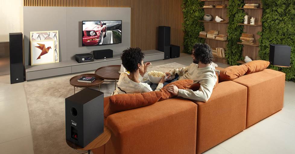 A couple watching TV with a 5.1 JBL speaker system