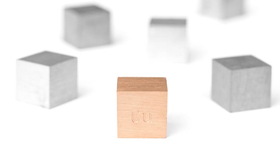 Several cube blocks of metal, with a copper block in the center