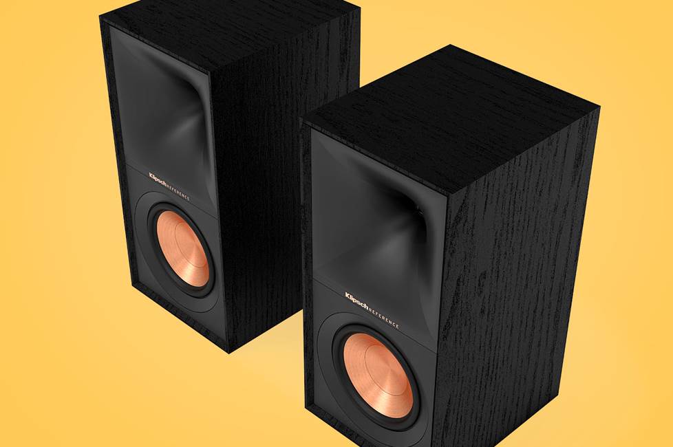 A pair of Klipsch Reference bookshelf speakers on a yellow background