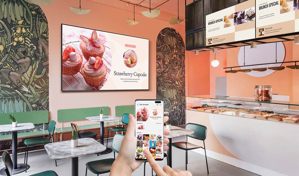 wall mounted video display in a restaurant being controlled with a phone