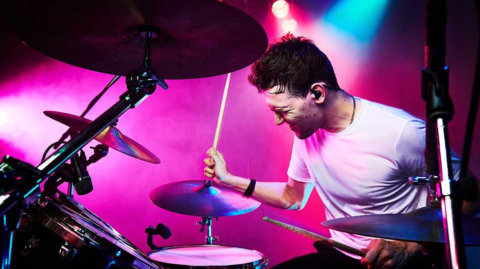 drummer playing live with in-ear monitors