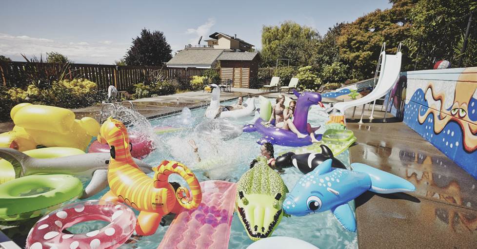 Image of a pool filled with colorful pool toys, without HDR