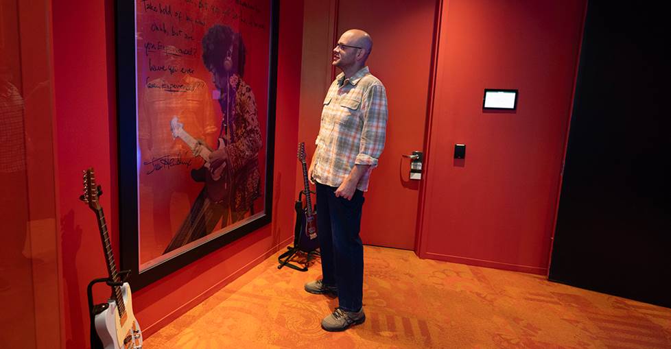 Jeff looking at guitars and poster