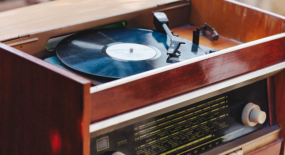 close up on record player inside a vintage hi-fi console