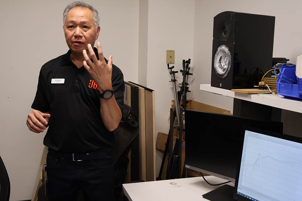 An Nguyen talking about a speaker with lycopodium powder on its woofer.