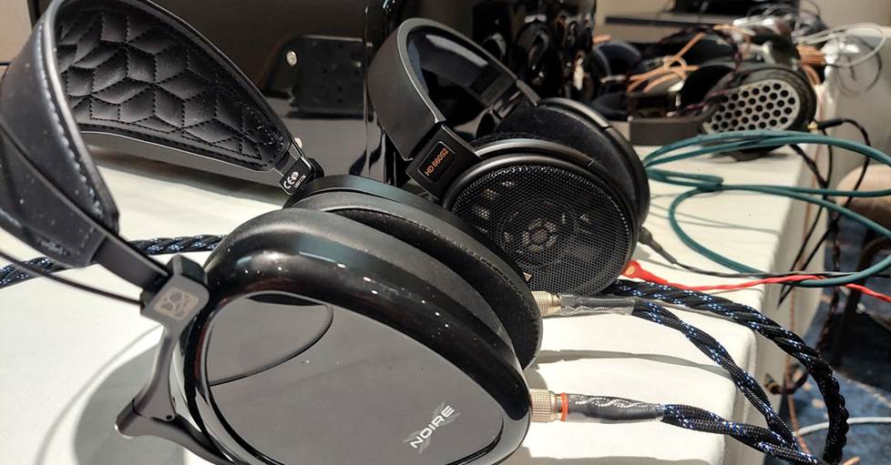 A row of over-the-ear headphones on a table