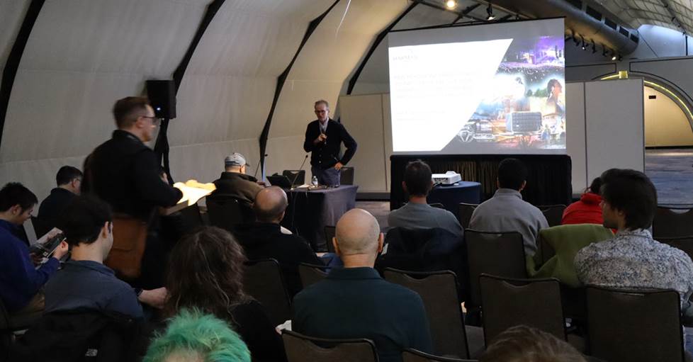 Dr Sean Olive from Harman talking to a group of people